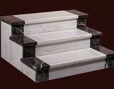 three white marble steps with black trim