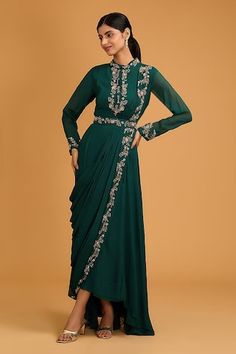 Bottle green draped gown with floral hand embroidery and pleating detail. Paired with an embroidered belt. - Aza Fashions Festive Green Draped Dresses, Fitted Anarkali Draped Dress, Fitted Draped Anarkali Dress, Fitted Anarkali Dress With Draped Style, Formal Traditional Drape Pre-draped Gown, Evening Gown With Floral Embroidery In Green, Formal Pre-draped Traditional Gown, Green Floral Embroidered Evening Gown, Elegant Green Gown With Floral Embroidery