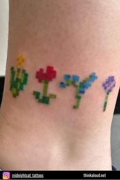 an image of a tattoo that looks like pixelated flowers on the side of a woman's leg