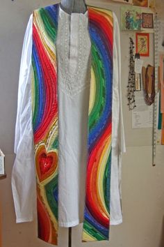 a woman's white shirt and colorful cardigan on a mannequin