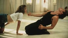 two people are doing yoga in a large room