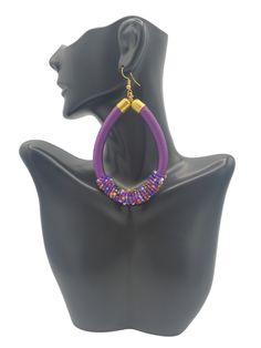 THE COLOR PURPLE! These large hoop earrings in purple with a mixture of beads are playful and so lightweight, making them a no brainer statement. Our favorite detail...subtle bead accents that add that little extra something. FEATURES ☆ Embroidery thread wrapped cord earrings☆ Beaded Accents☆ Color: Primary color purple with accent colors☆ Earring Back: Gold plated ball & coil fishhook ear wire☆ Earrings are light-weight ☆ Beautifully handmade by talented Kenyan artisans☆ Ships from the U.S. ☆ S Cord Earrings, Wrapped Hoop Earrings, The Color Purple, Earrings Purple, Earrings Beaded, Large Hoop Earrings, Wire Earrings, Earring Backs, Ear Wire