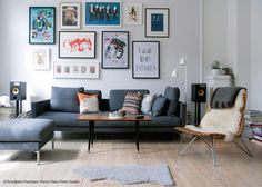 a living room filled with furniture and pictures on the wall