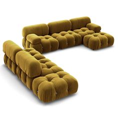 a large couch made out of two different pieces of fabric with buttons on the back