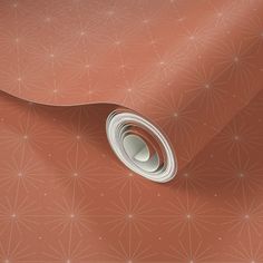 a close up view of a wallpaper with an orange background and white circles on it