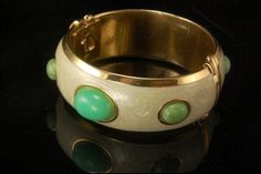 "This is a very beautiful, unique and vintage FRANCESCA ROMANA JADE CABOCHONS PEARL ENAMEL GOLD TONE bracelet. The fantastic bracelet has nice green jade cabochons with pearl enamel and gold tone metal (bottom has FRANCESCA ROMANA). The bracelet has a very exotic and elegant feel to it. It measures 7 1/4\" x 1\" . The bracelet is in very good condition. 0.7 BR" Elegant Oval Green Bangle, Elegant Green Oval Bangle, Vintage Green Bangle For Wedding, Green Jade, Gold Enamel, Jade Green, Gold Tone Metal, Bangle Bracelet, Arm Band