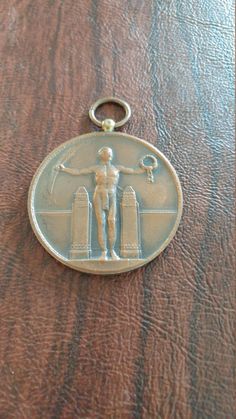 a medal with a man on it sitting on top of a wooden table