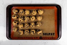 chocolate chip cookies are arranged on a cookie sheet and ready to go into the oven