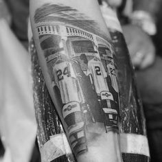 a black and white photo of a man's arm with trains on it