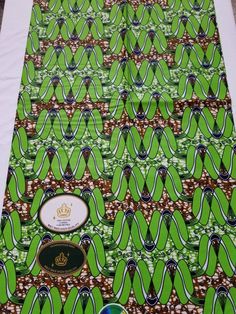 an image of a table cloth with green and brown designs on it's sides