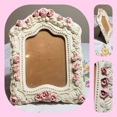 an ornate white frame with pink roses on the edges and bottom, sitting on a table