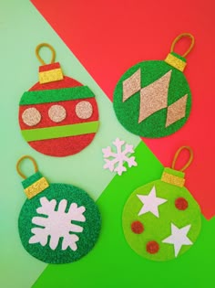 three felt christmas ornaments on a green and red background