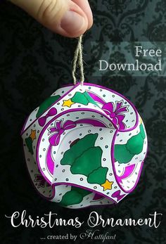 a hand holding a paper christmas ornament with the text free printables