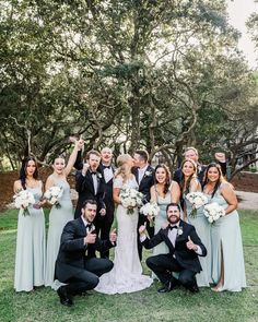 a group of people that are standing in the grass