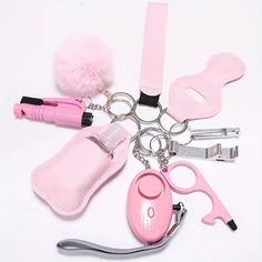 a pink keychain with various items attached to it and a pom - pom