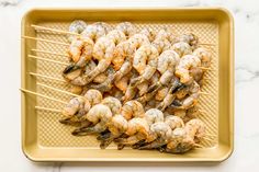 grilled shrimp skewers on a gold tray