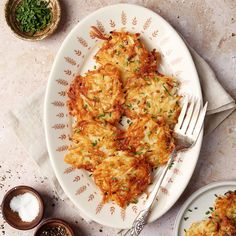 a white plate topped with lasagna covered in cheese and parmesan sauce