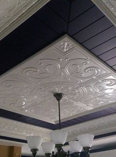 a chandelier hanging from the ceiling in a room with blue and white walls