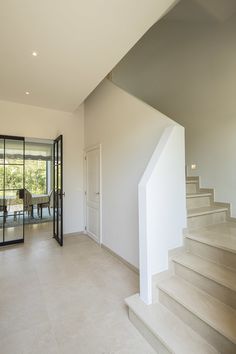 an empty living room with stairs leading up to the second floor