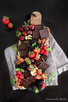 chocolate dessert board with strawberries, raspberries, almonds and other fruit