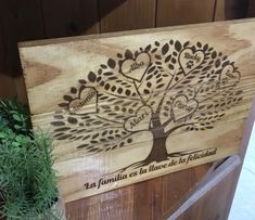 a wooden box with a family tree on the front and back side, in spanish