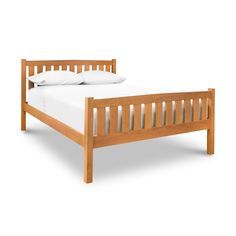 a wooden bed frame with white sheets and pillows on it's headboard, against a white background