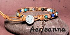 Moon Single Row Beaded Leather Wrap Bracelet by Aerieanna Made with 100% USA naturally dyed leather in golden brown and an assortment of gemstone beads that can include African Turquoise, Lapis Lazuli, Red Jasper, Clear Quartz, Rose Quartz, Landscape Jasper, Unikite, Carnelian, Mookite, Sodalite, Amethyst with Czech fire-polished crystals. Closes with a copper moon and stars button at 7 & 8". Metal wing charm. Want another size? Request a custom order! Bohemian Hand Wrapped Round Beaded Bracelets, Bohemian Round Wrap Bracelet As Gift, Hand Wrapped Round Bohemian Beaded Bracelets, Bohemian Style Round Wrap Bracelet As Gift, Spiritual Hand Wrapped Leather Bracelet For Festivals, Hand Wrapped Spiritual Leather Bracelet For Festival, Bohemian Wrap Bracelet As Gift, Bohemian Leather Beaded Bracelet For Healing, Bohemian Leather Bracelet With Natural Stones For Gift