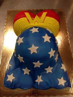 a cake shaped like a woman's head with stars on it and a superman hat