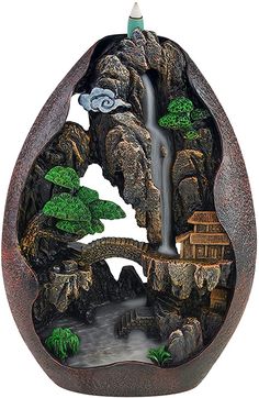 an egg shaped sculpture with a waterfall in the middle