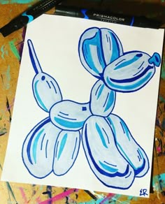 a drawing of blue flowers on a white paper with black marker pen next to it