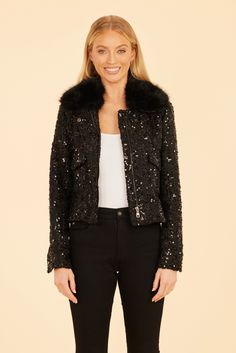 If you’re looking to add some sparkle to your fall wardrobe, our Faux Fur Trimmed Sequin Jacket is the perfect piece to ensure that you shine in any setting. The shimmering sequins catch the light beautifully, while the voluminous faux fur collar adds luxury and warmth. Whether you're dressing up for an evening out or making a bold statement during the day, this zip-up jacket delivers a stunning mix of glamour and texture. Sequined Faux fur collar Zip-up front Available in Black Dry clean Style: Evening Long Sleeve Fall Outerwear, Glamorous Winter Outerwear For Night Out, Chic Winter Evening Biker Jacket, Black Cropped Jacket For Winter Evenings, Black Cropped Jacket For Winter Evening, Black Cropped Jacket For Evening In Winter, Elegant Winter Biker Jacket For Party, Black Outerwear For Evening In Fall, Elegant Winter Party Biker Jacket