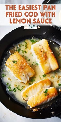 some fish is cooking in a skillet with lemon sauce and parsley on the side