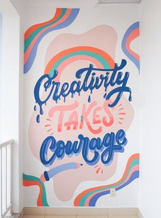 there is a large mural in the corner of this room that says creativity takes courage