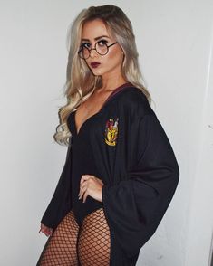 a woman in fishnet stockings and glasses posing for the camera with her hands on her hips