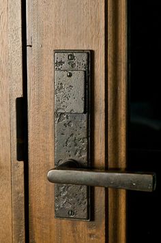 an old door handle on a wooden door