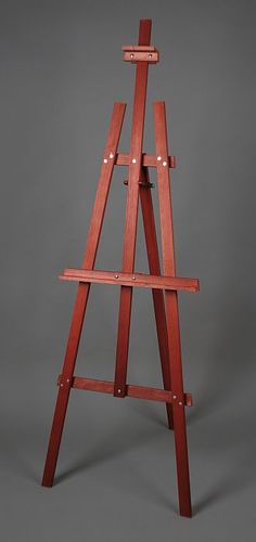 a wooden easel stands on a gray background