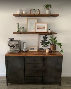 an old dresser with some plants on top and coffee maker in the bottom shelf above it