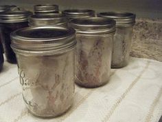 several jars are lined up on a table