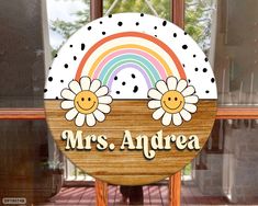 a wooden sign that says mrs andra with flowers in the center on a stand