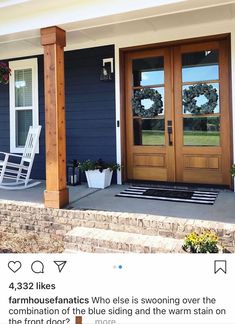 front porch with rocking chair and wreaths on the door way to a blue house