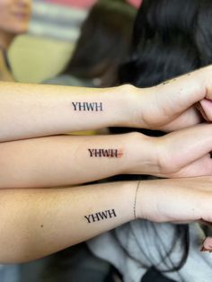 three people with matching tattoos on their arms