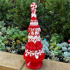 a red and white christmas tree made out of candy canes