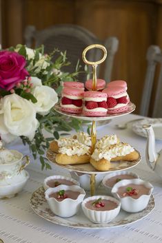 three tiered trays filled with pastries on top of a table