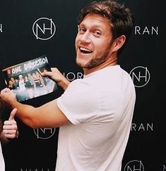 a man holding a record in front of a woman with her hand on the cover