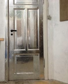 the door is made of metal and has glass panels