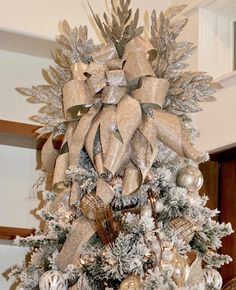 a decorated christmas tree with silver and gold decorations