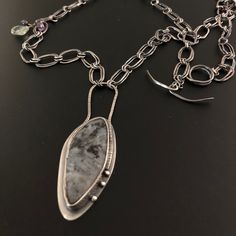 Noweigen Moonstone is one of my favorite stones. There's the black and gray that's a girls best friend. But, it's the beautiful colors that perk out that we girls really love. This gem is surrounded with textured silver and hangs from a handmade hammered oval link chain that's oxidized. A great gift for yourself. Why not! Unique Gray Jewelry For Gifts, Unique Gray Jewelry For Gift, Unique Gray Jewelry As Gift, Elegant Black Moonstone Jewelry, Oxidized Moonstone Jewelry Gift, Elegant Moonstone Jewelry With Oxidized Finish, Moonstone Pendant Jewelry With Large Stone, Elegant Oxidized Moonstone Jewelry, Silver Hand Forged Labradorite Necklace