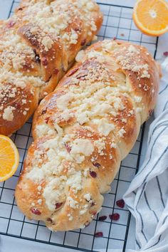 two oranges and some bread on a cooling rack