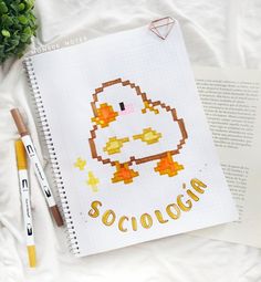 a cross stitch book with an image of a duck and the word scologa written on it