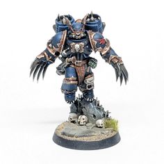 a blue and black warhammer with skulls on it's face, standing in front of a white background